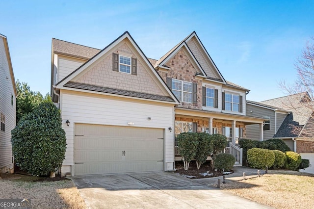 craftsman inspired home with a garage and a porch