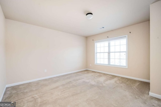 empty room featuring light carpet