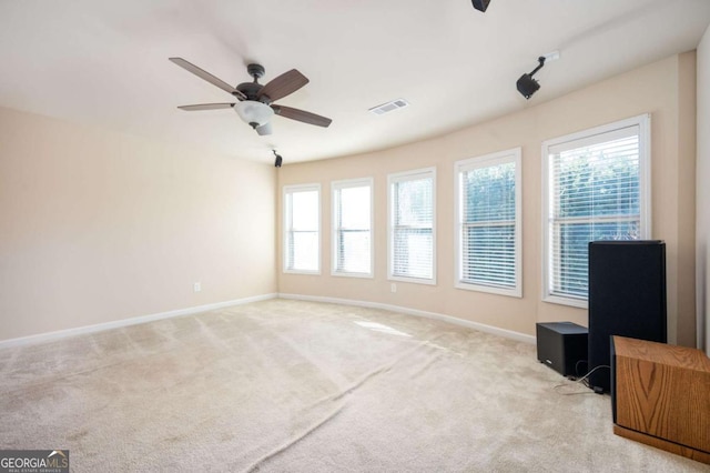 spare room featuring ceiling fan and light carpet