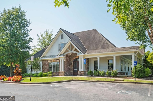 view of front of home with a porch and a front lawn