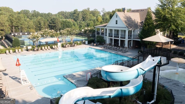 view of pool with a patio and a water slide