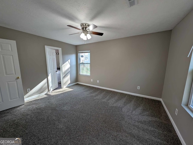 carpeted spare room with a textured ceiling and ceiling fan