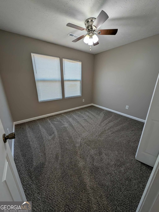 carpeted empty room featuring a textured ceiling and ceiling fan