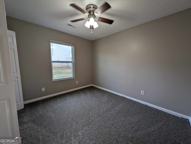 carpeted spare room with ceiling fan and a textured ceiling