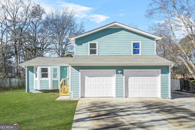 view of front of house featuring a garage and a front lawn