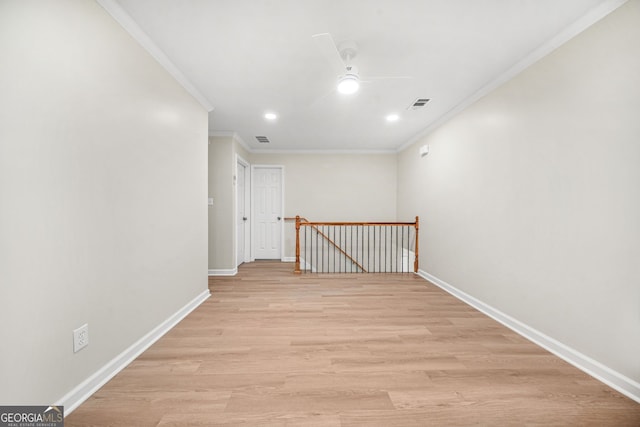 hallway with ornamental molding and light wood-type flooring