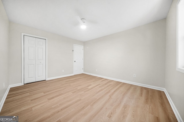 unfurnished bedroom with a closet, ceiling fan, and light hardwood / wood-style flooring