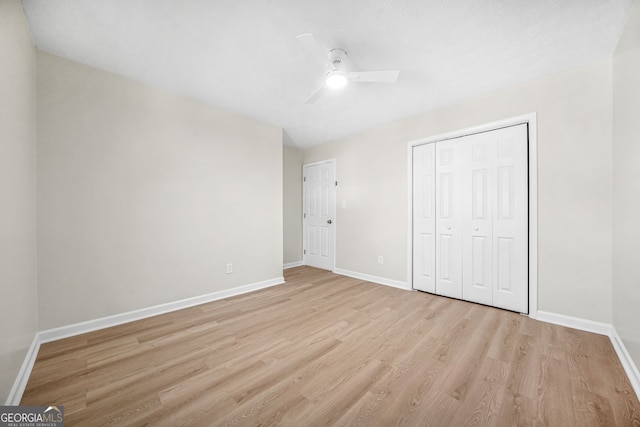 unfurnished bedroom with a closet, ceiling fan, and light wood-type flooring