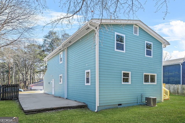 rear view of property featuring central AC, a yard, and a patio