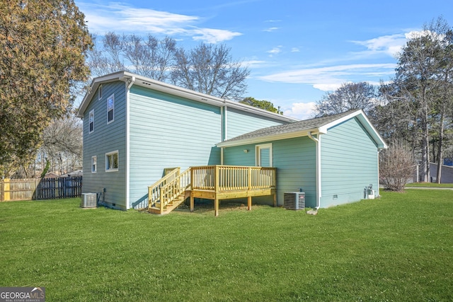 rear view of property with central AC, a yard, and a wooden deck