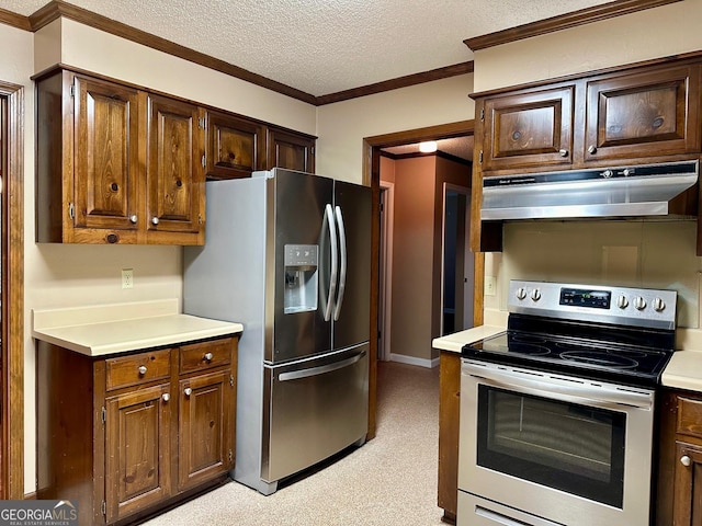 kitchen with a textured ceiling, crown molding, and appliances with stainless steel finishes