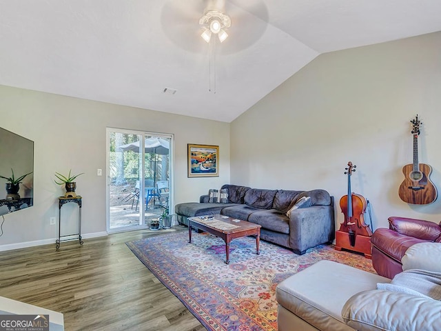 living room with hardwood / wood-style flooring, ceiling fan, and vaulted ceiling