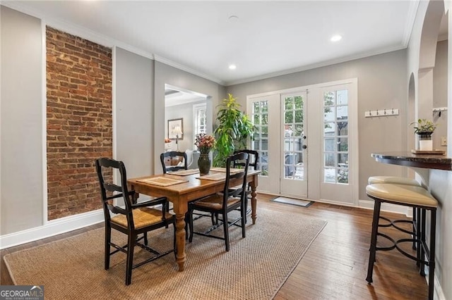 dining space featuring dark hardwood / wood-style flooring, french doors, and crown molding