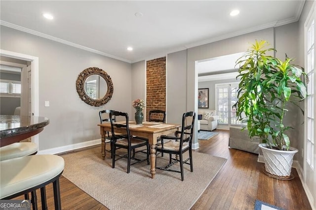 dining space featuring dark hardwood / wood-style flooring and crown molding