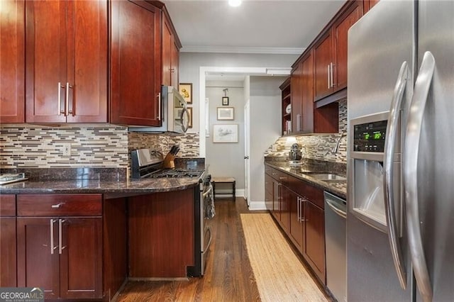 kitchen featuring stainless steel appliances, dark stone countertops, tasteful backsplash, and dark wood-type flooring