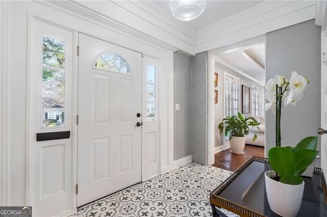 entryway with light wood-type flooring and crown molding