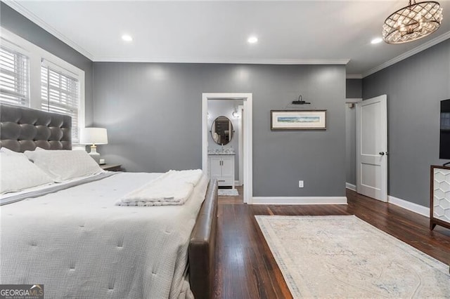 bedroom with ensuite bathroom, an inviting chandelier, ornamental molding, and dark wood-type flooring