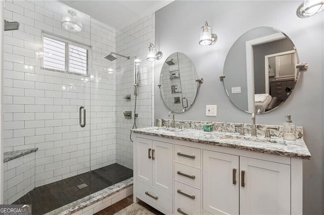 bathroom with a shower with door and vanity