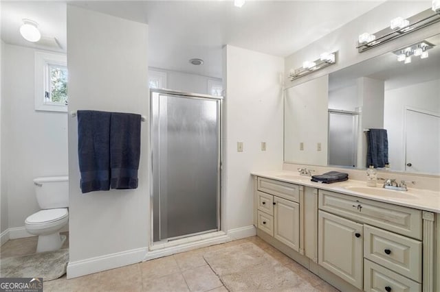 bathroom featuring toilet, a shower with door, vanity, and tile patterned floors