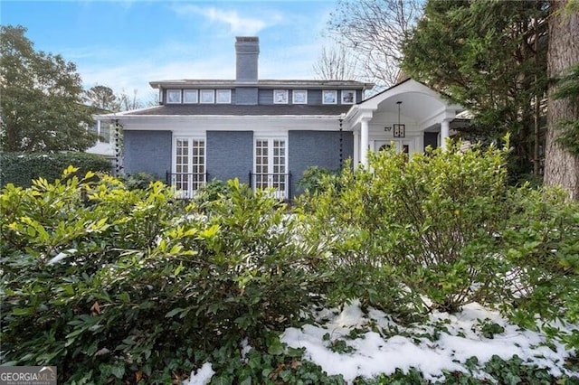 view of snow covered rear of property