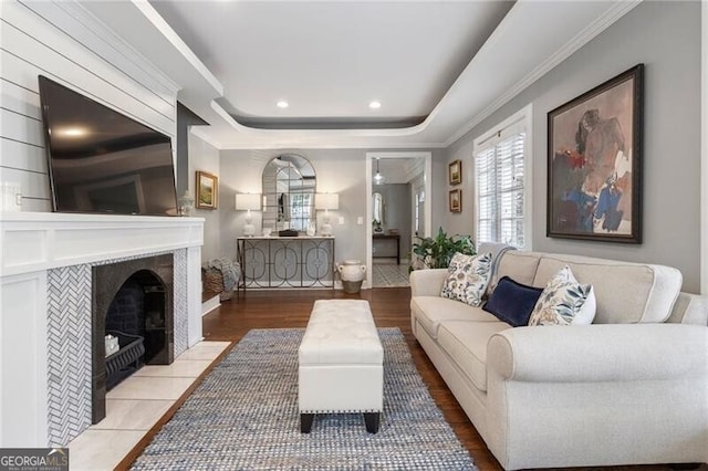 living room featuring a fireplace and a raised ceiling