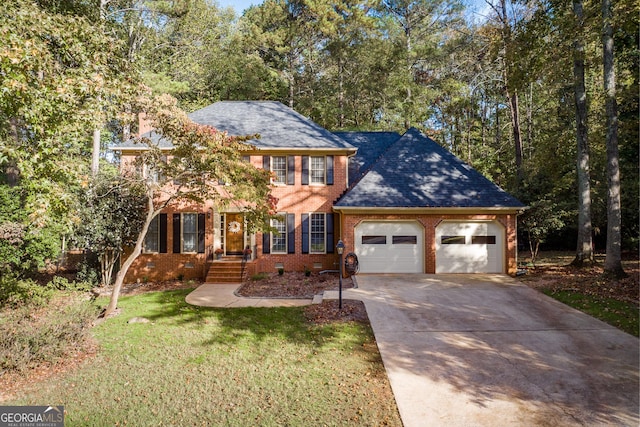 view of front of house featuring a front yard and a garage