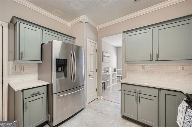 kitchen with backsplash, a textured ceiling, stainless steel fridge with ice dispenser, and light tile patterned floors