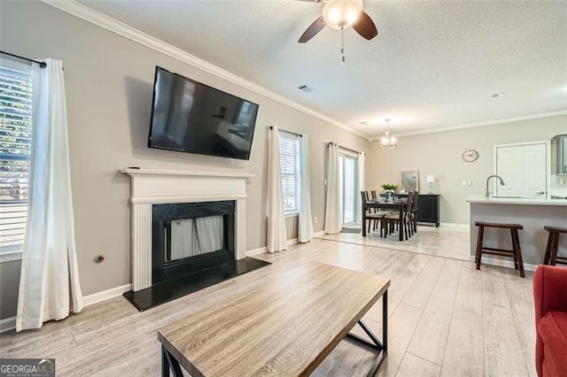 living room featuring a healthy amount of sunlight and crown molding