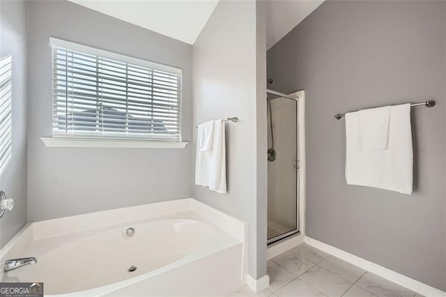 bathroom with separate shower and tub and lofted ceiling