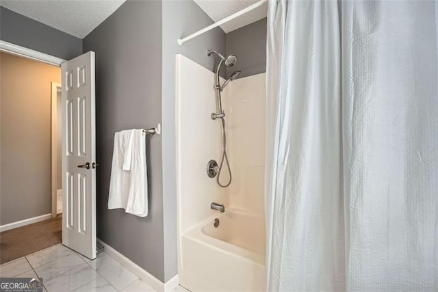 bathroom featuring a textured ceiling and shower / bath combo with shower curtain