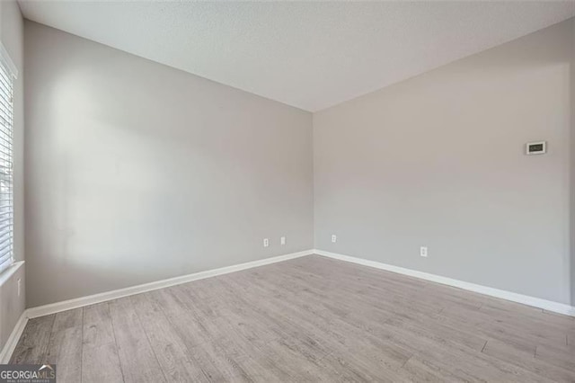 unfurnished room featuring light hardwood / wood-style floors