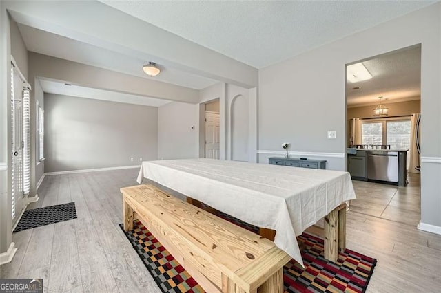 bedroom with a textured ceiling and light hardwood / wood-style floors