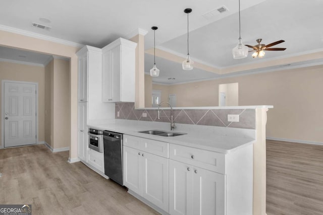 kitchen featuring tasteful backsplash, white cabinets, appliances with stainless steel finishes, ornamental molding, and sink