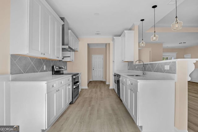 kitchen with decorative light fixtures, stainless steel appliances, light wood-type flooring, white cabinetry, and sink