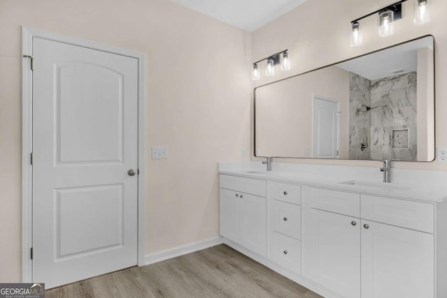 bathroom featuring a shower, vanity, and wood-type flooring