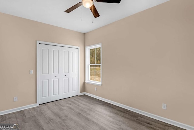 unfurnished bedroom with ceiling fan, light hardwood / wood-style floors, and a closet