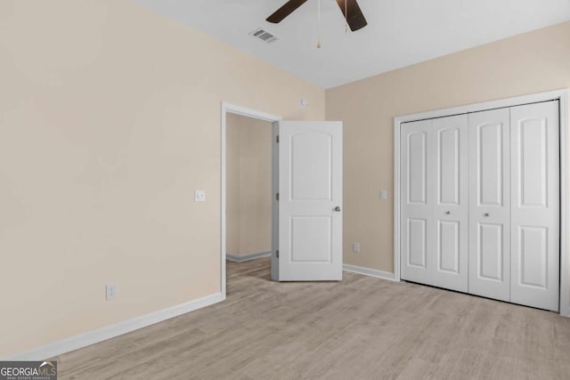 unfurnished bedroom featuring a closet, ceiling fan, and light wood-type flooring