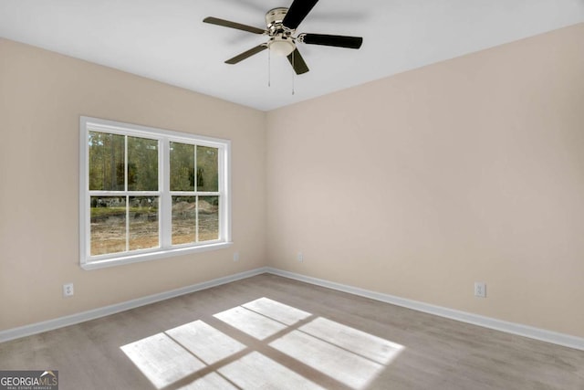 spare room with ceiling fan and light hardwood / wood-style floors