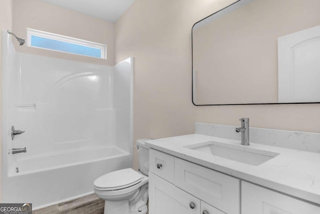 full bathroom with toilet, vanity, shower / tub combination, and hardwood / wood-style floors