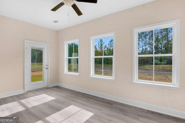 unfurnished room with ceiling fan and light hardwood / wood-style flooring