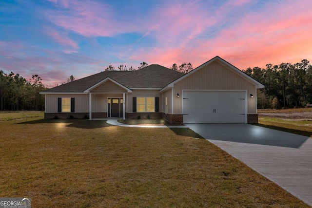 ranch-style house featuring a lawn and a garage