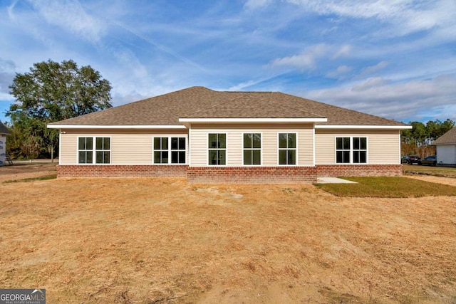 back of house featuring a yard