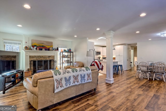 living room with a fireplace and hardwood / wood-style floors