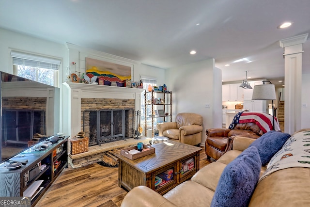 living room with a fireplace and light hardwood / wood-style floors