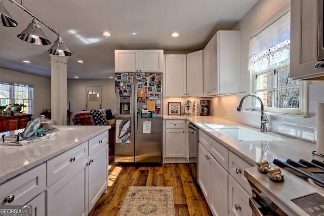 kitchen featuring ornate columns, dark hardwood / wood-style flooring, white cabinetry, appliances with stainless steel finishes, and sink