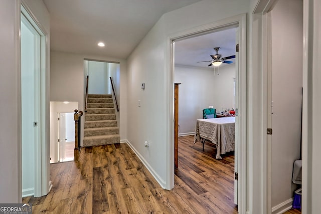 hallway featuring lofted ceiling and hardwood / wood-style flooring