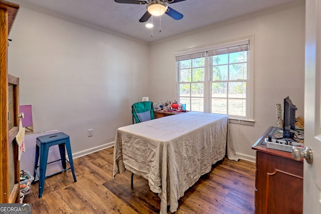 bedroom with ceiling fan, ornamental molding, and wood-type flooring