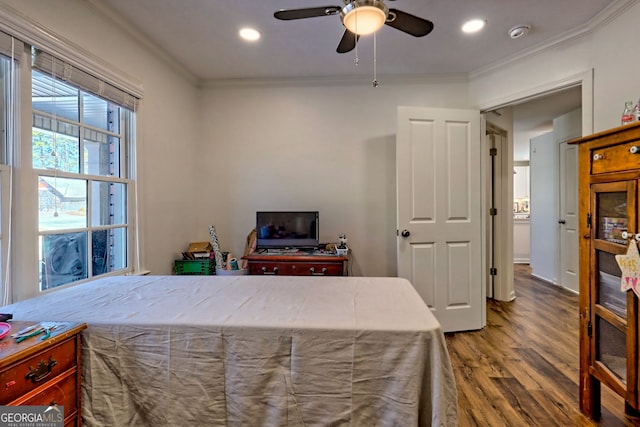 bedroom featuring ceiling fan, hardwood / wood-style flooring, and crown molding