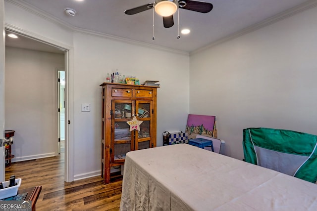 bedroom featuring ceiling fan, dark wood-type flooring, and ornamental molding