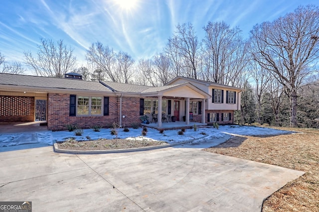 view of front of home featuring covered porch and a carport